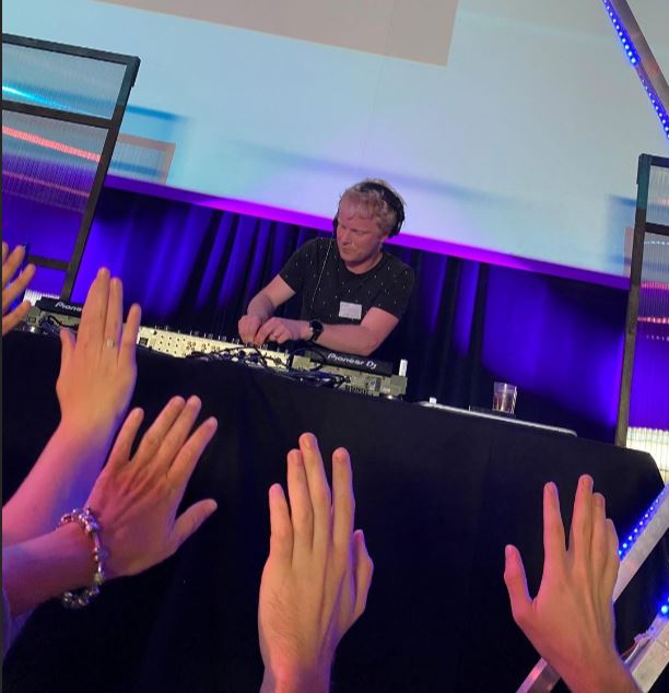 Feystival achter de mixer, handen van het publiek reiken omhoog naar de DJ-booth.